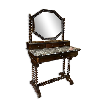 Antique English mahogany dressing table with carved details, black marble, and mirror.