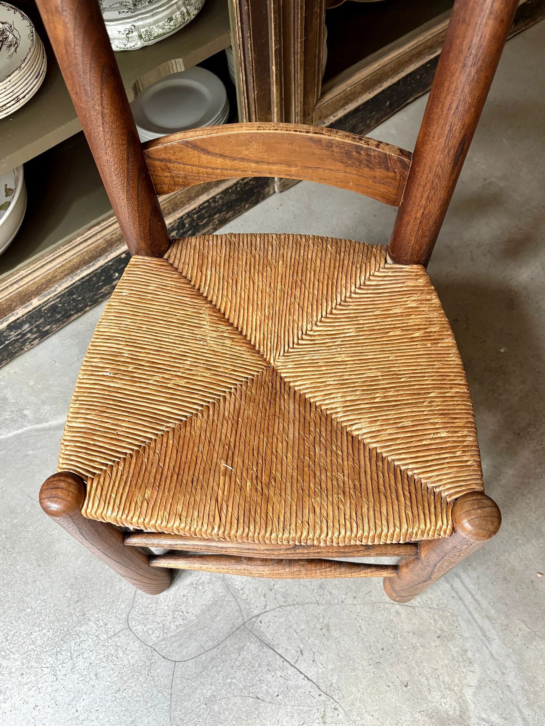 Provençal chair in dark wood and woven straw.