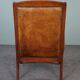 Armchair in sheepskin with wood