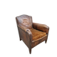 Antique club chair in patinated brown leather, early 20th century English style.