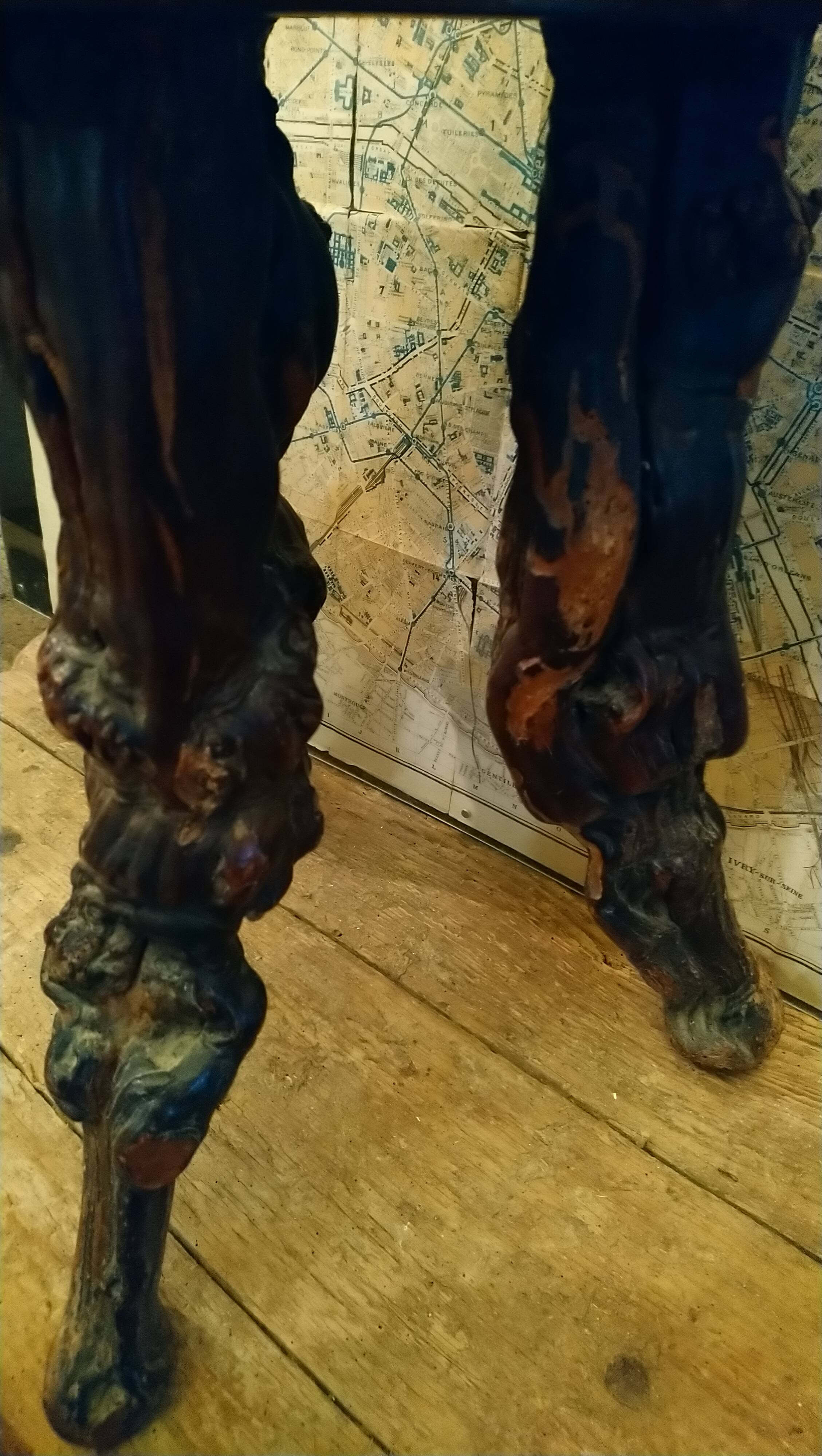 Brutalist tripod stool made from vine stumps.