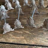 Series of 12 monogrammed silver metal knife holders