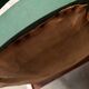 Green faux leather bridge chair
