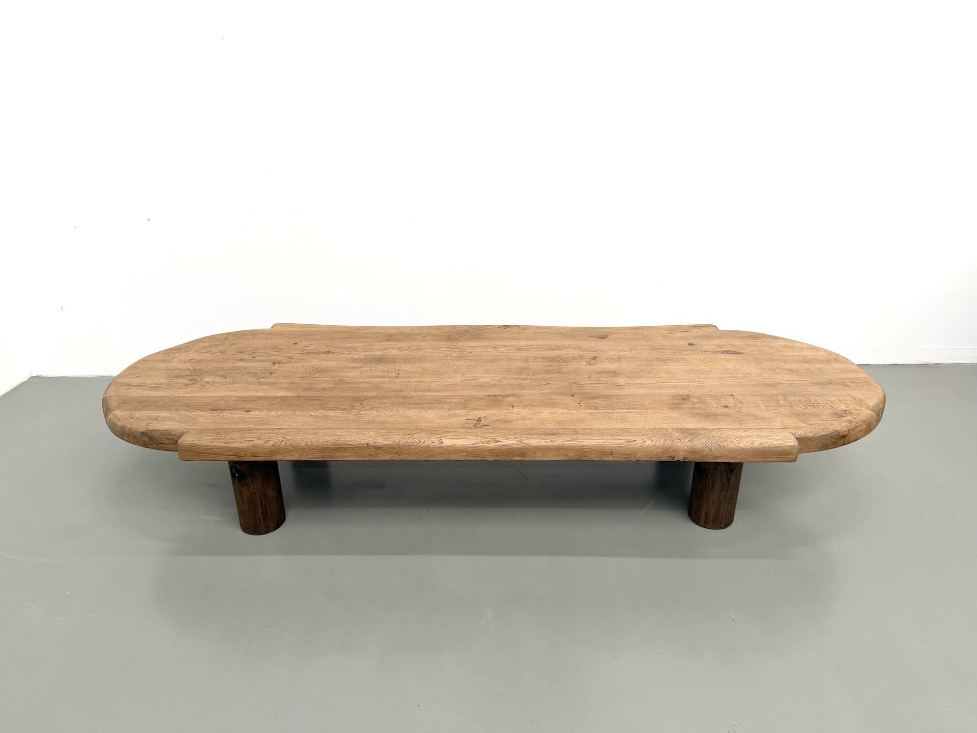 XXL oval coffee table in solid oak, cylindrical base, 1950s.