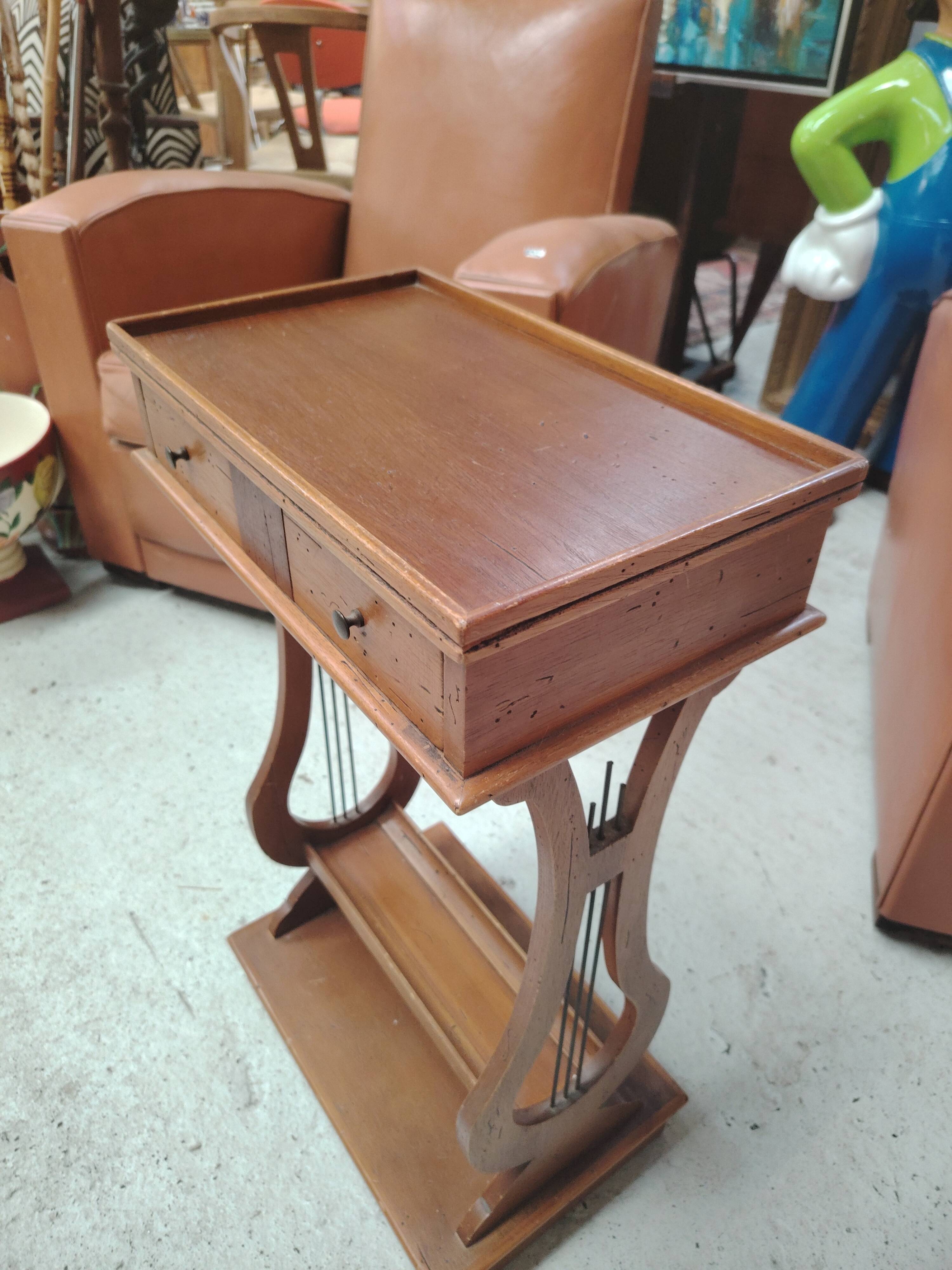 Vintage end table with lyre legs and two drawers.