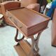 Vintage end table with lyre legs and two drawers.