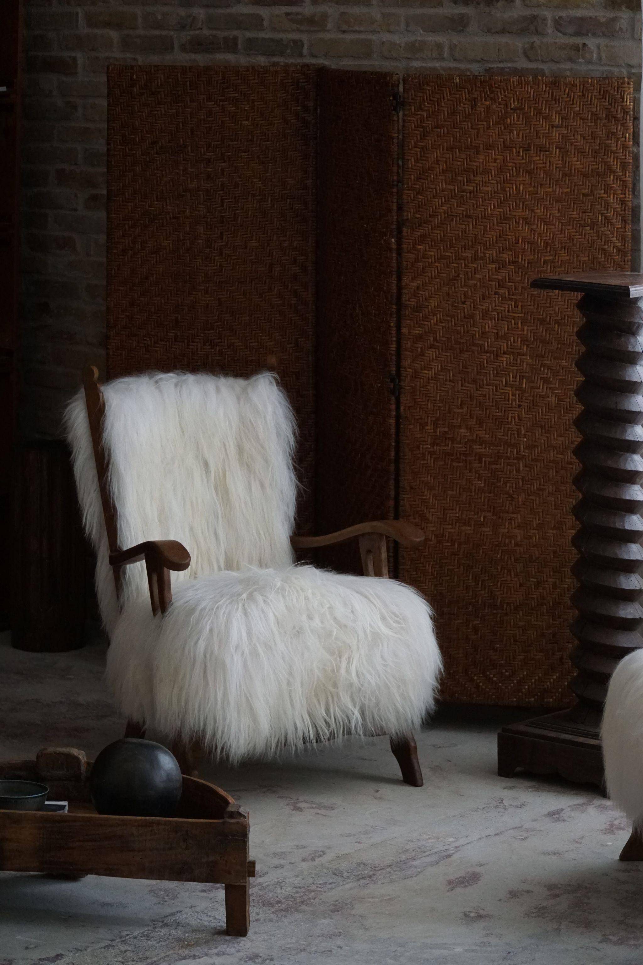 Pair of Scandinavian armchairs in oak and long-haired Icelandic sheepskin by Henning Kjærnulf, 1950.