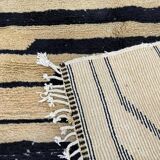 Handmade Moroccan rug in ecru with coloured patterns, 250cm x 150cm.