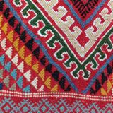 Red carpet with multicolored Berber patterns woven with hands
