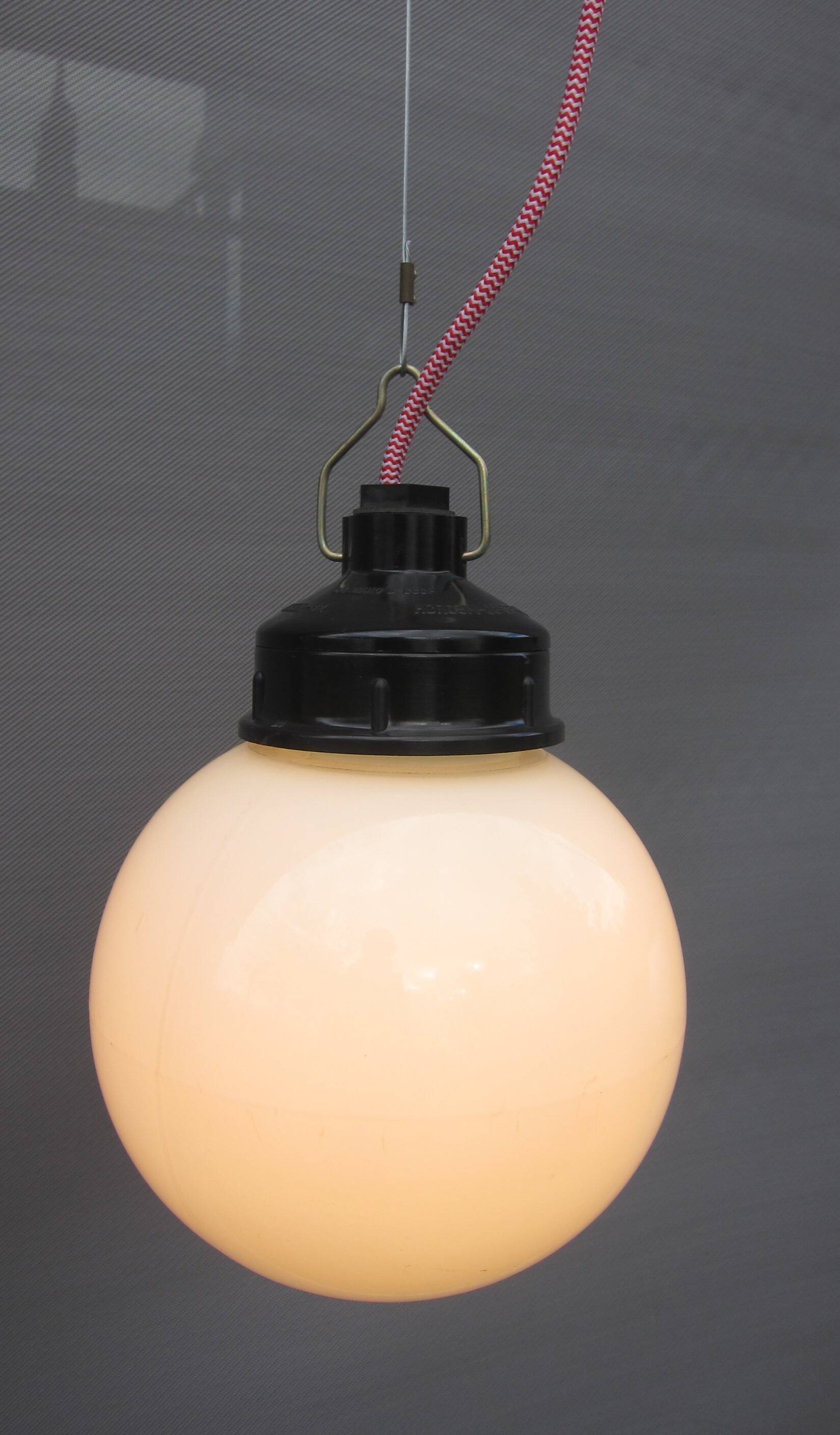 Trio of opal glass and bakelite globe pendant lights