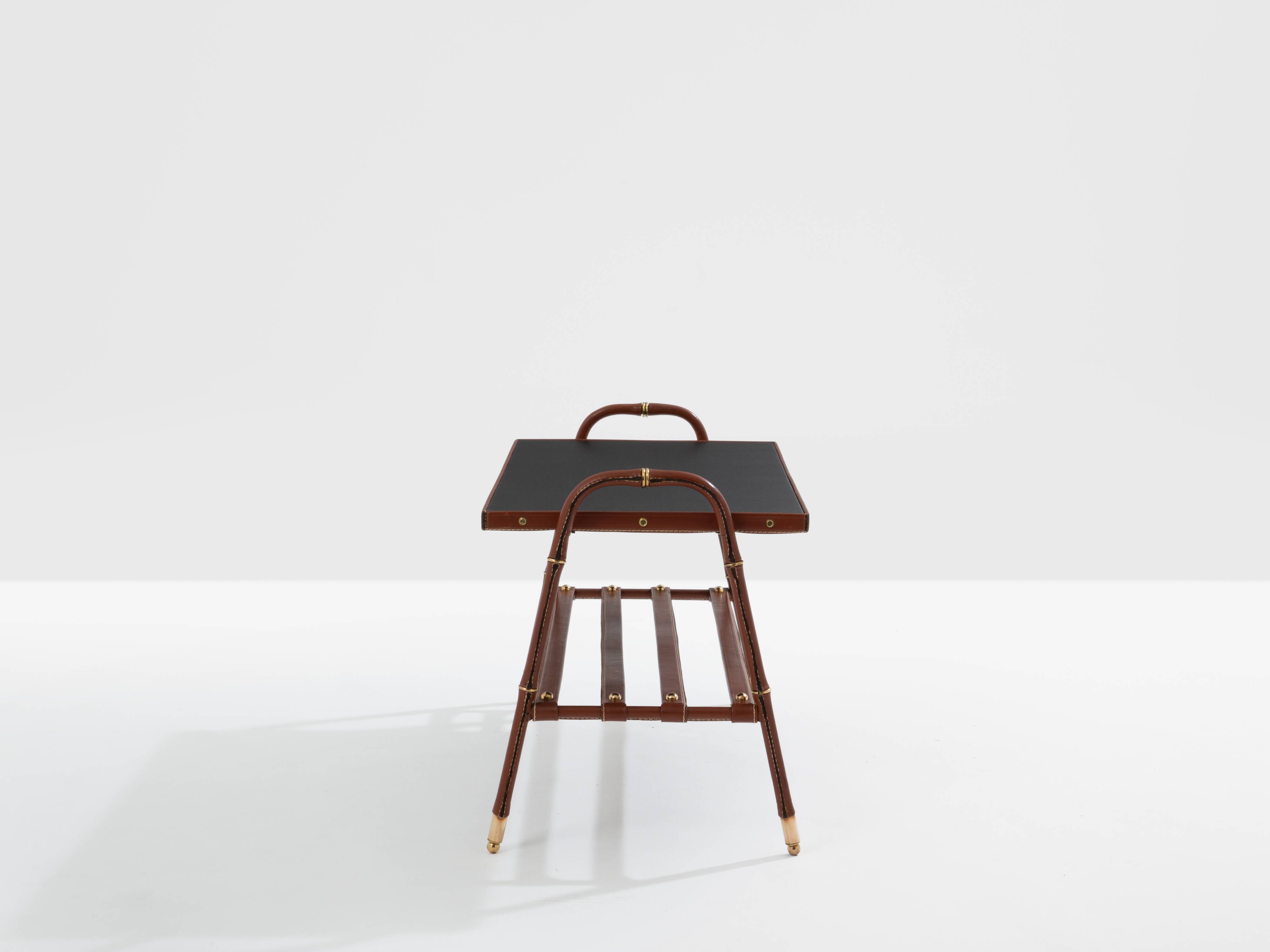 Jacques Adnet coffee table in red saddle-stitched leather and brass, 1950s