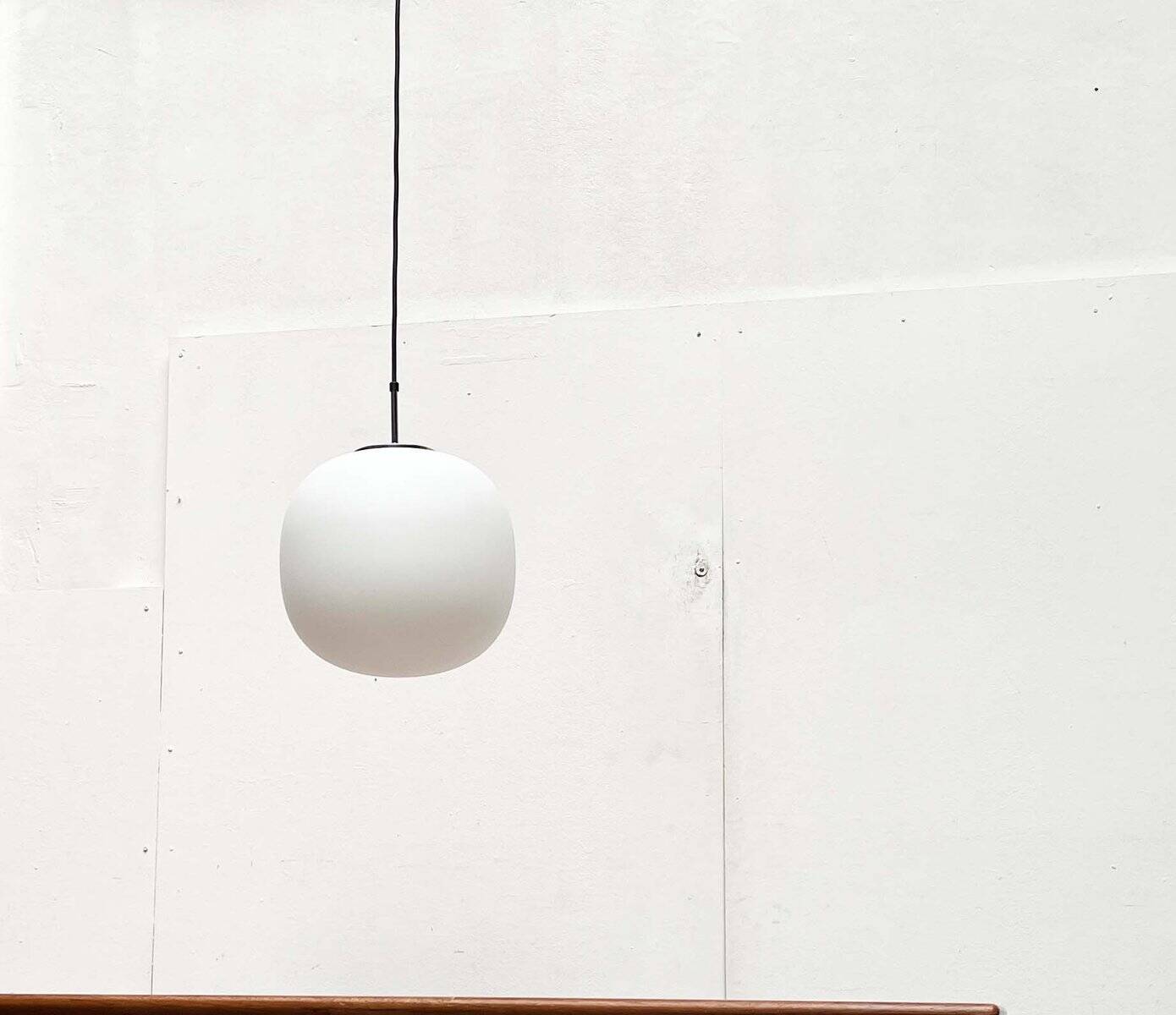 Minimalist suspended glass ball lamp from the vintage German space age by Glashütte Limburg, 1970s.