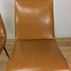 Pair of 1950s chairs with compass legs and brown faux leather.