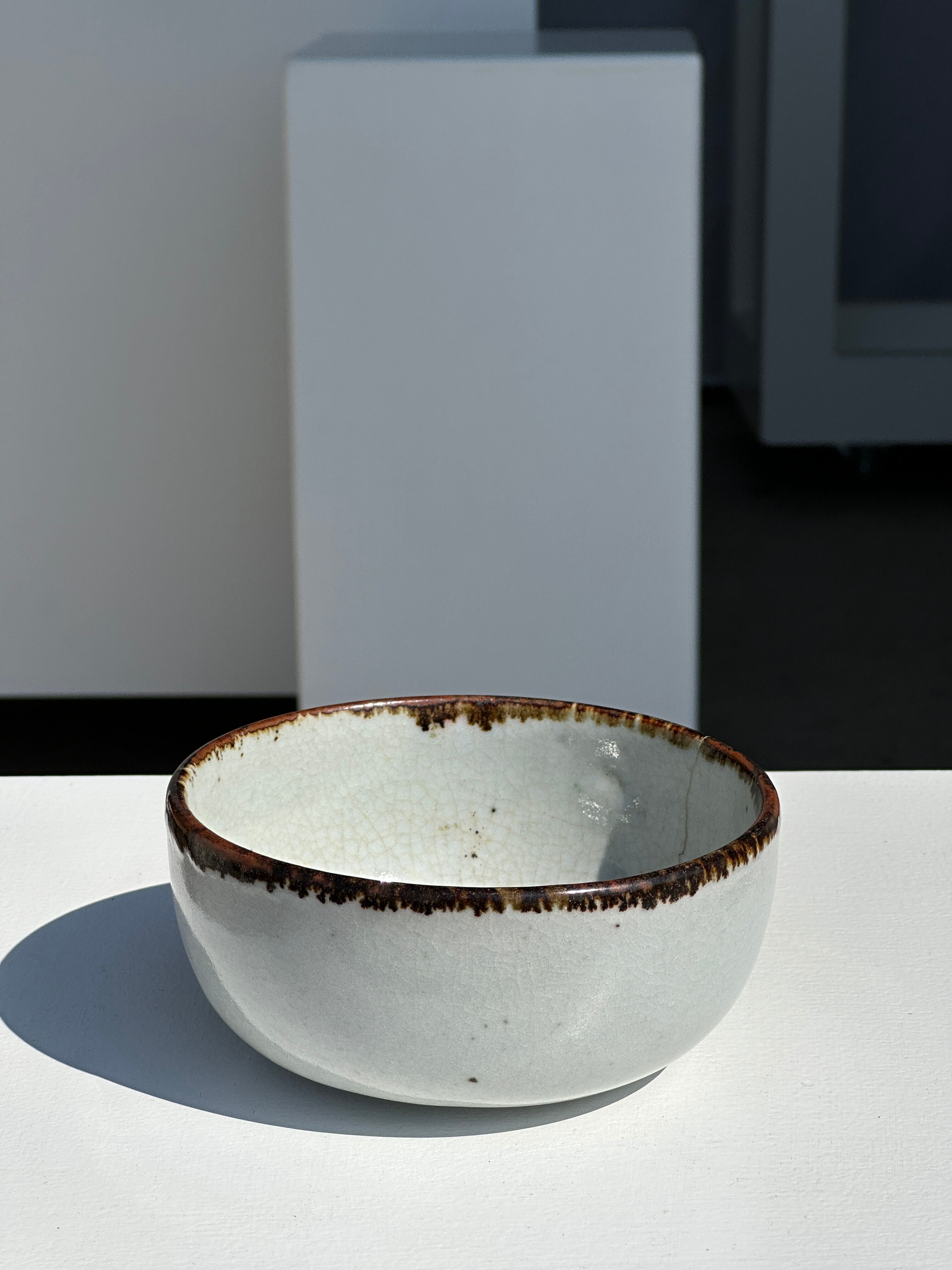 Small white glazed ceramic bowl black edges