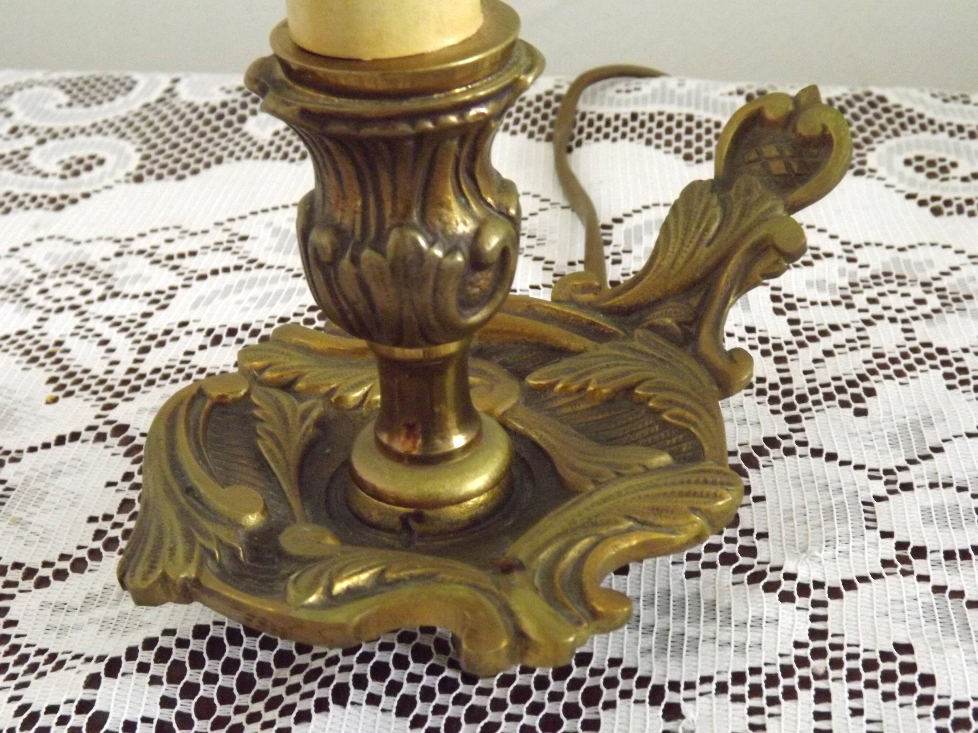 Vintage French bronze Wee Willie Winkie style lamp with red card shade.