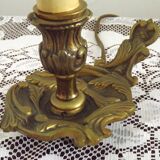 Vintage French bronze Wee Willie Winkie style lamp with red card shade.