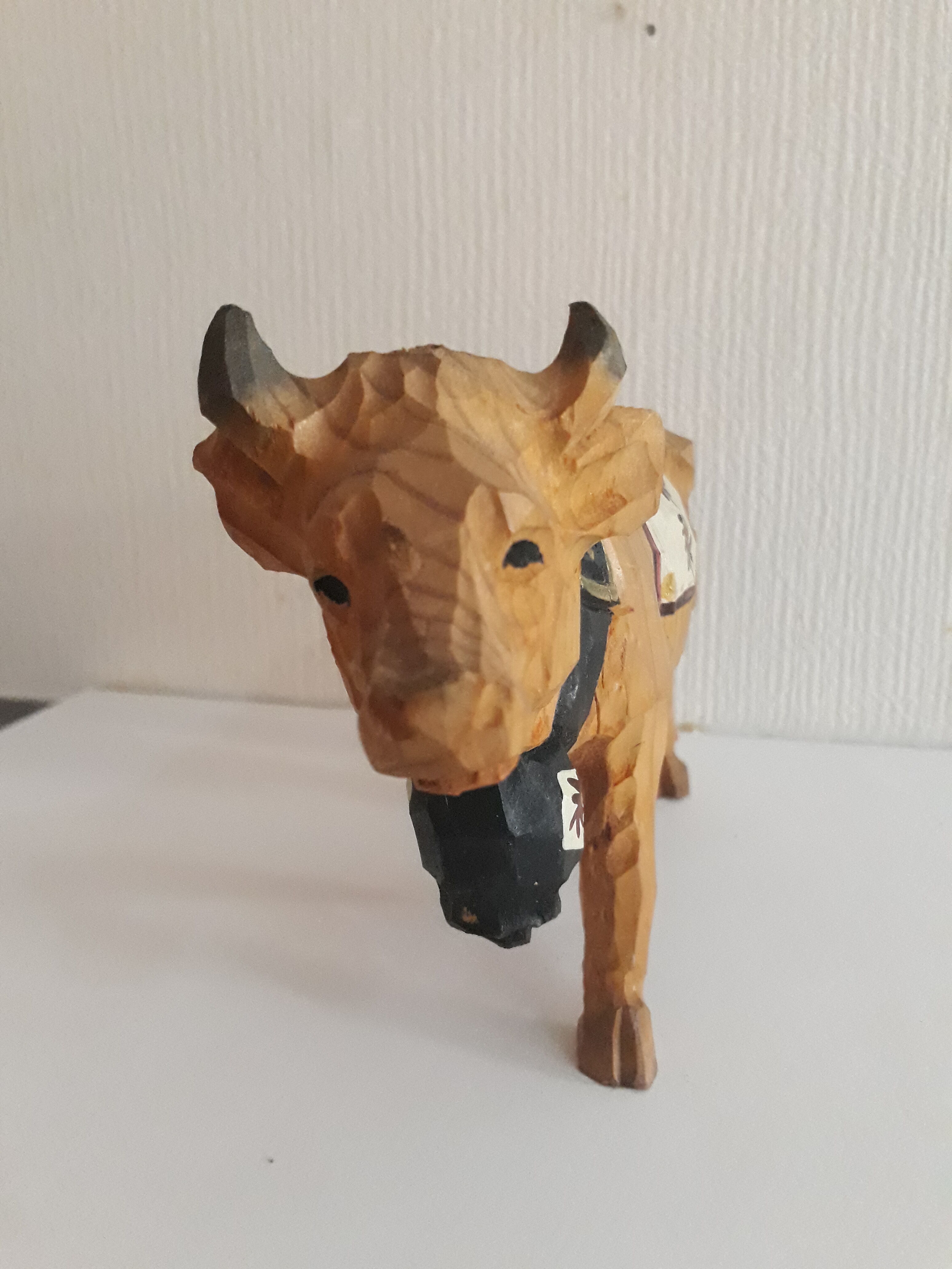 Carved and painted wooden cow