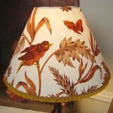 Rock-style table lamp with its vintage bird pattern shade