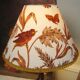 Rock-style table lamp with its vintage bird pattern shade
