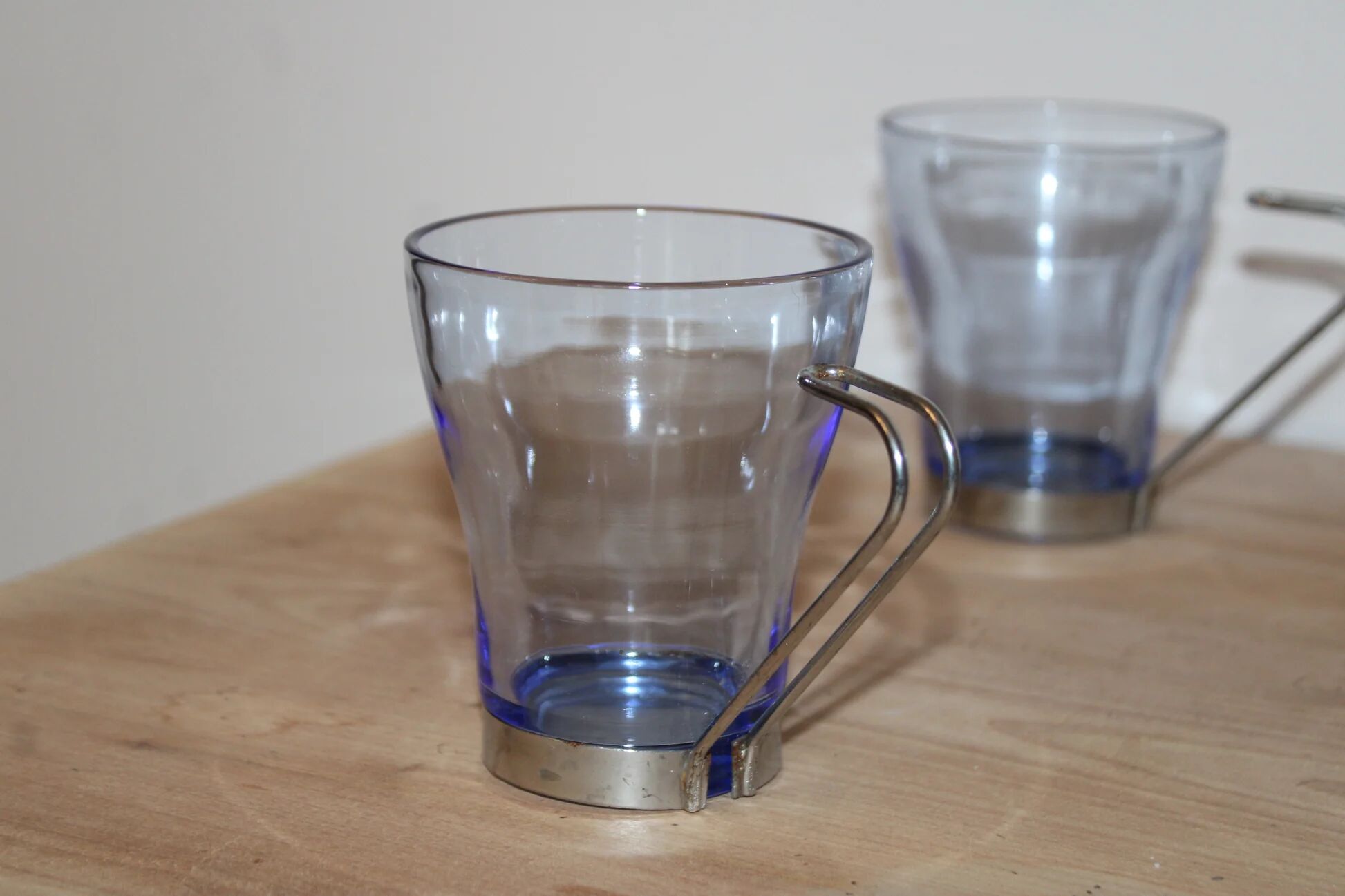 Set of 5 vintage blue-tinted glass cups with metal holders.
