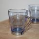 Set of 5 vintage blue-tinted glass cups with metal holders.