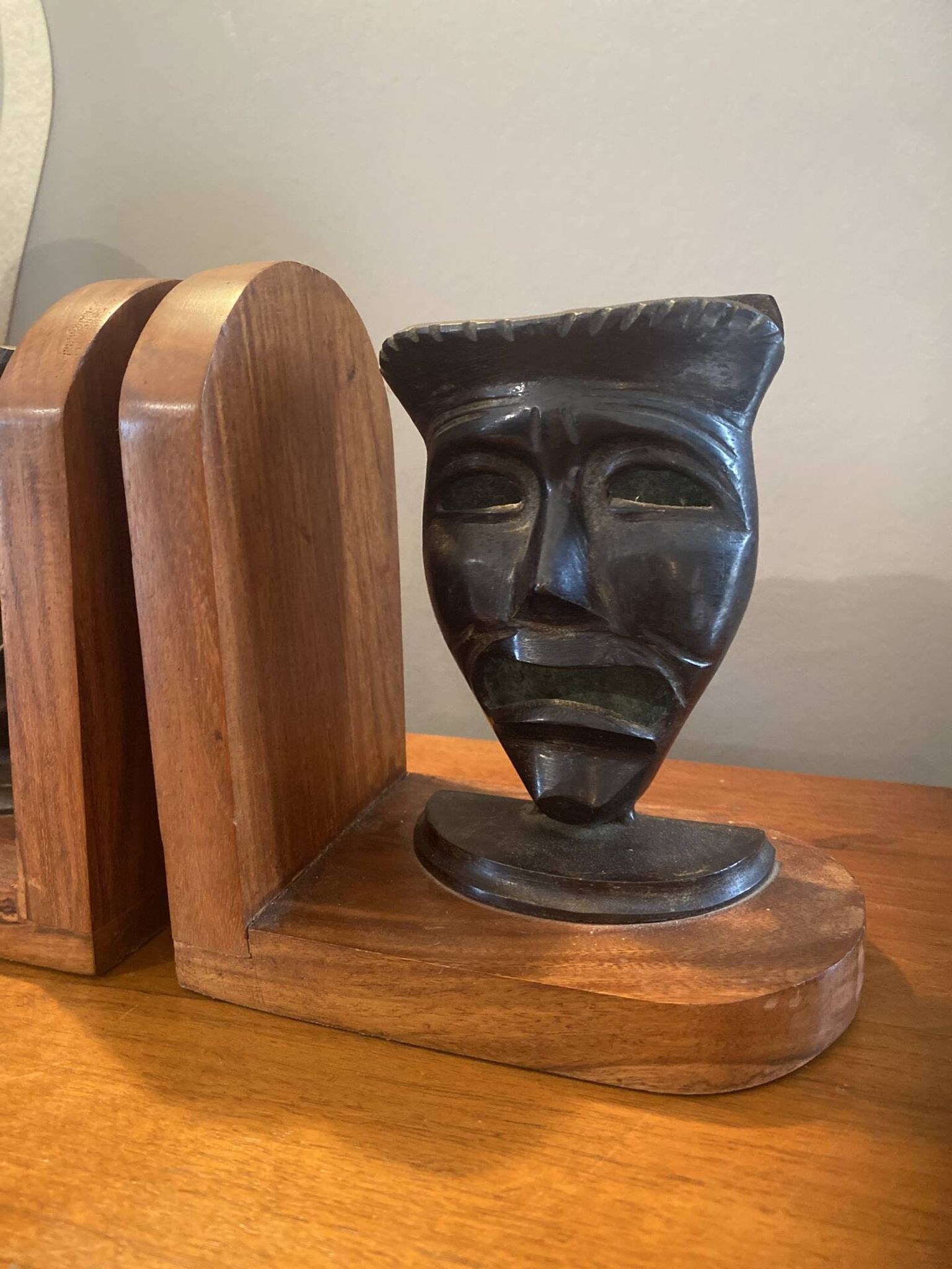 Pair of bronze bookends with masks