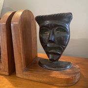 Pair of bronze bookends with masks
