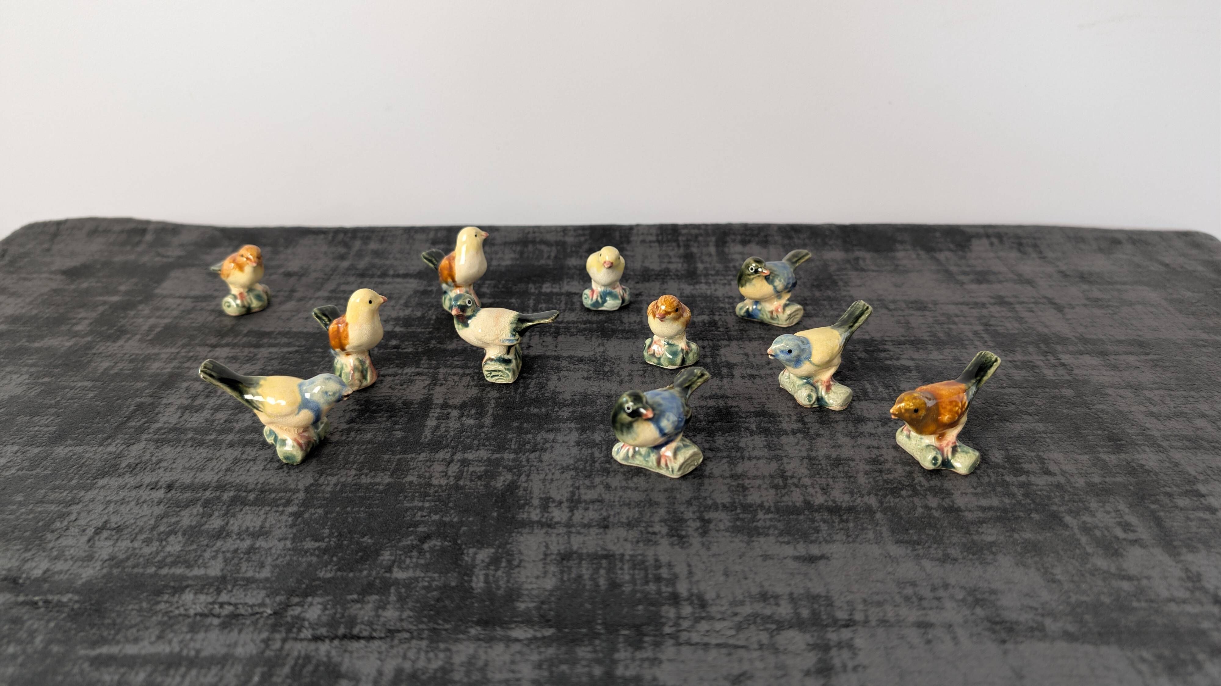 Set of 11 miniature birds in polychrome glazed ceramic.
