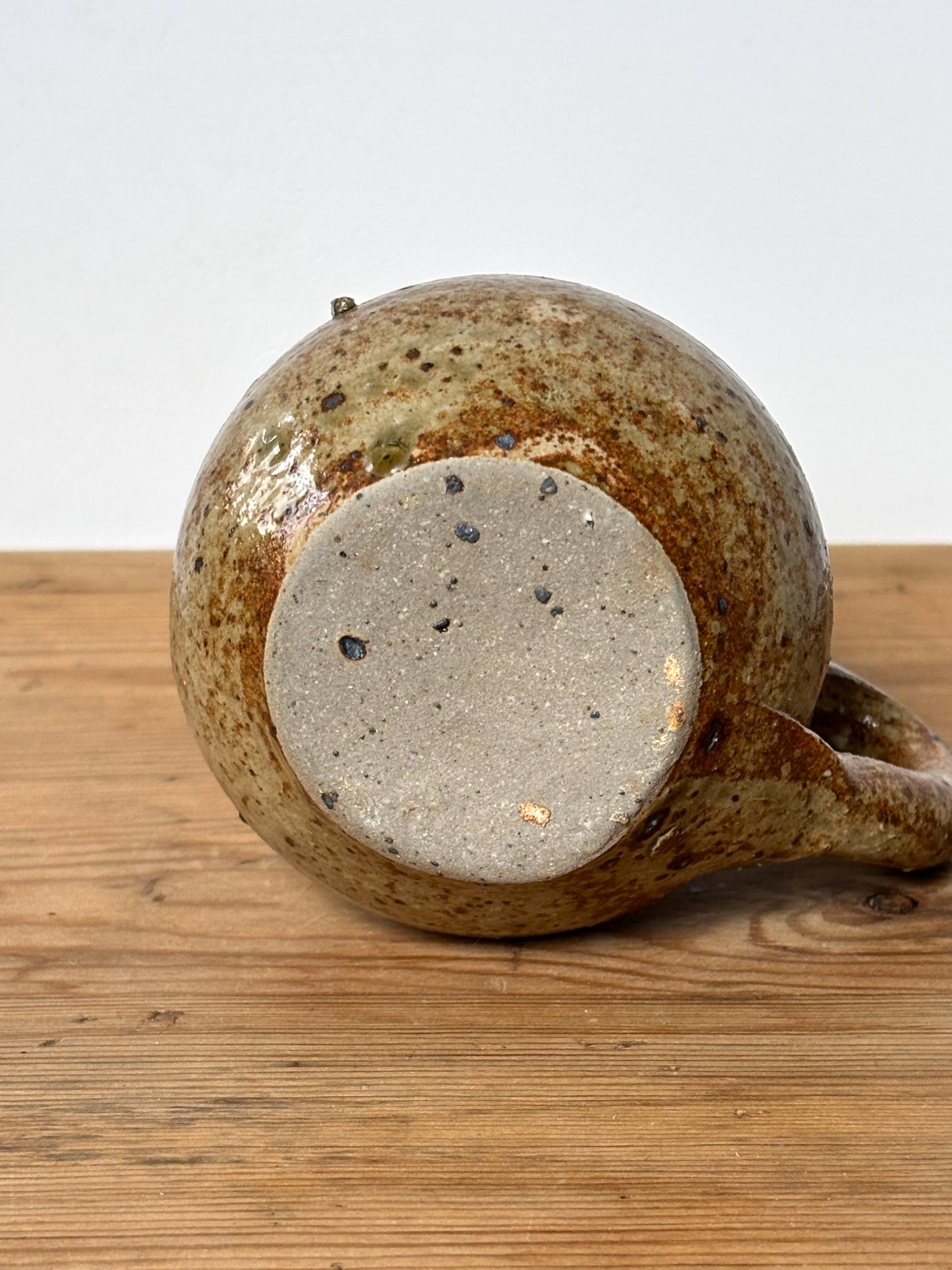Small beige speckled stoneware pitcher
