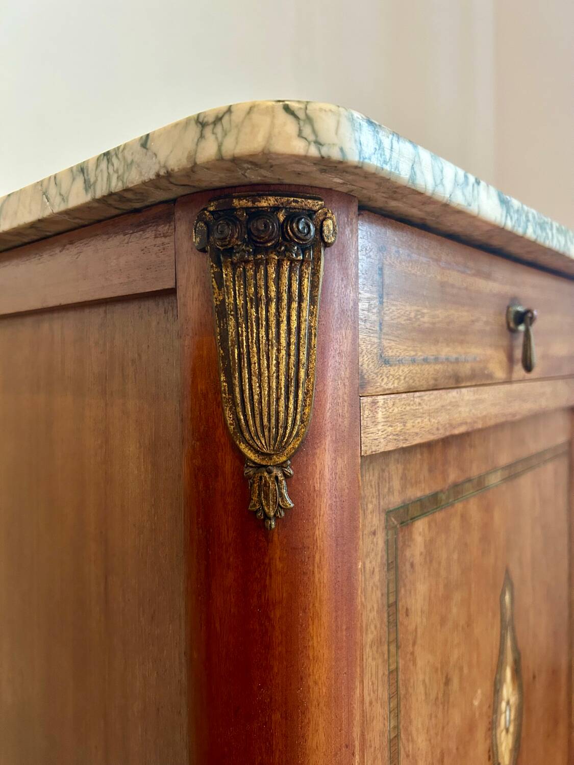 Antique bedside table in wood and marble – adorned with gilded brass ornaments –