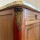 Antique bedside table in wood and marble – adorned with gilded brass ornaments –