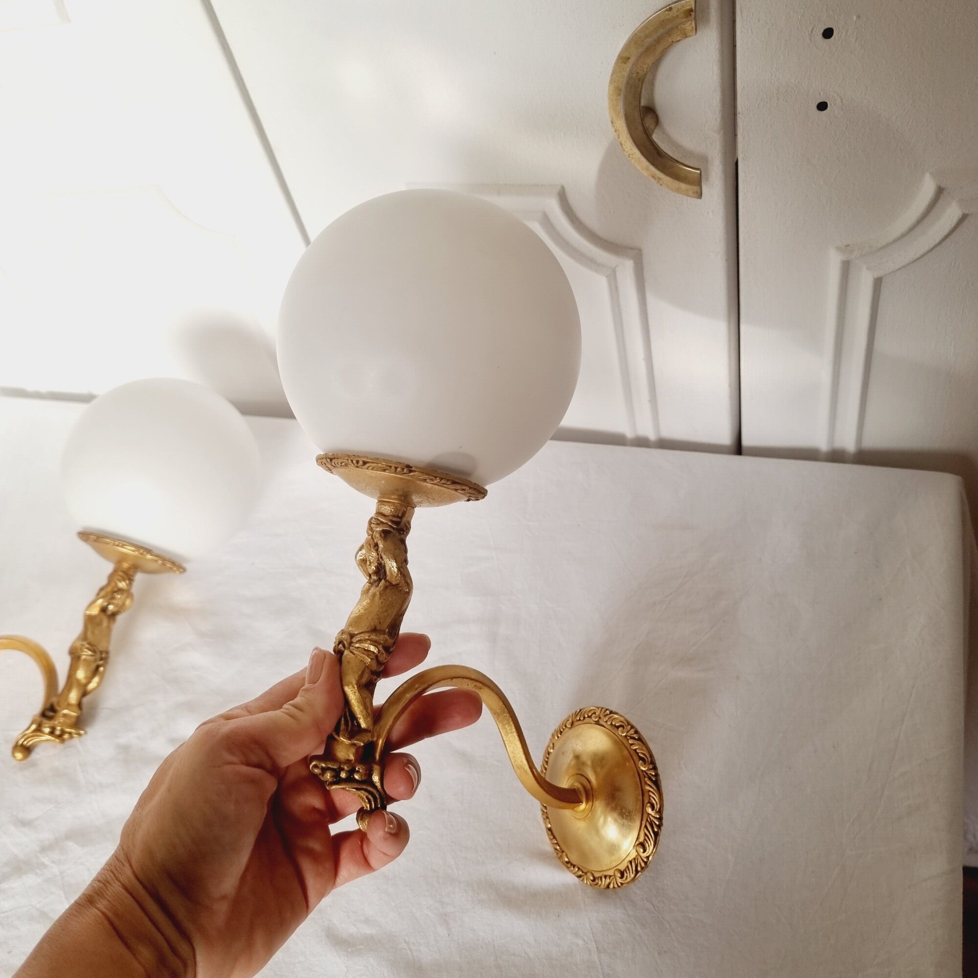 2 classic golden cherub wall lights and globe lampshades in perfect condition.