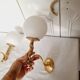 2 classic golden cherub wall lights and globe lampshades in perfect condition.