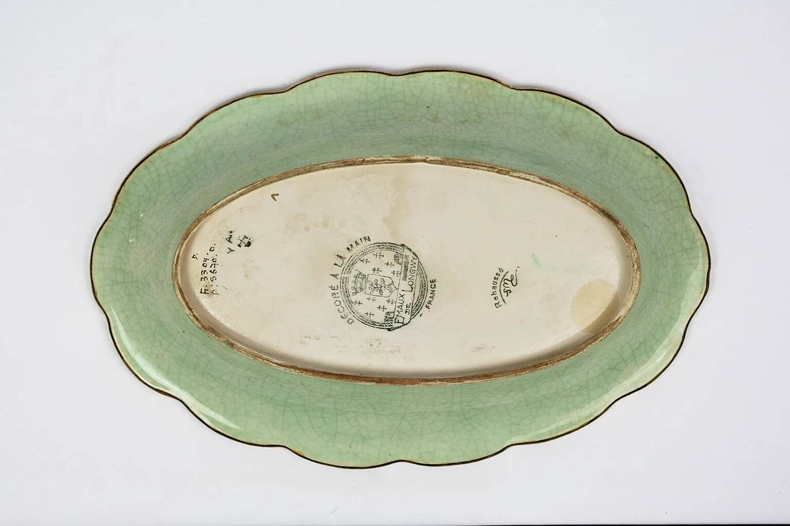 Longwy cup in cloisonné enamels on a green background, polychrome floral decoration and gold