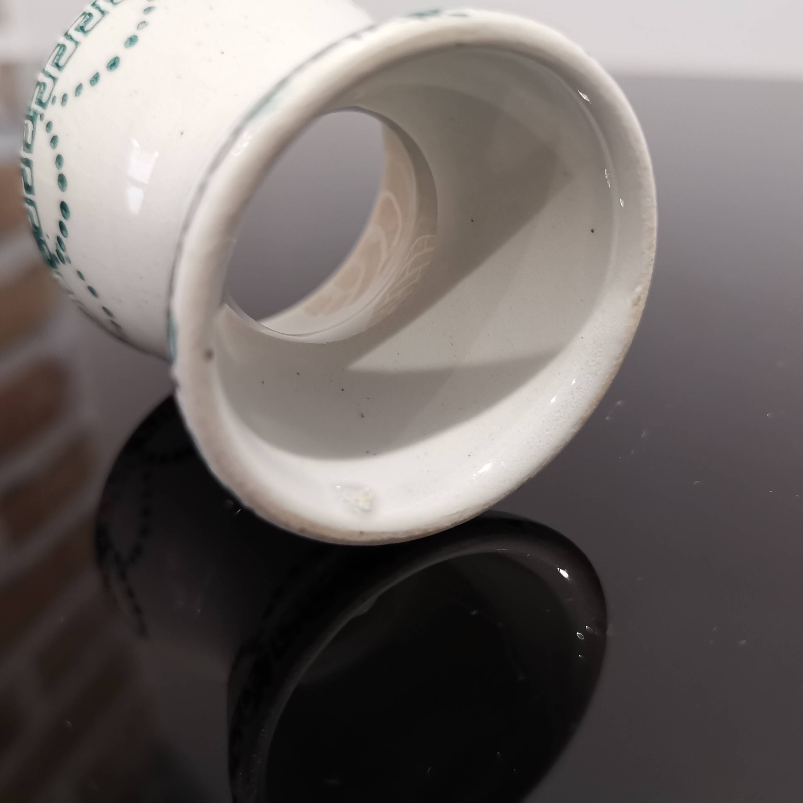 Old porcelain diabolo egg cup decorated with green frieze and garlands