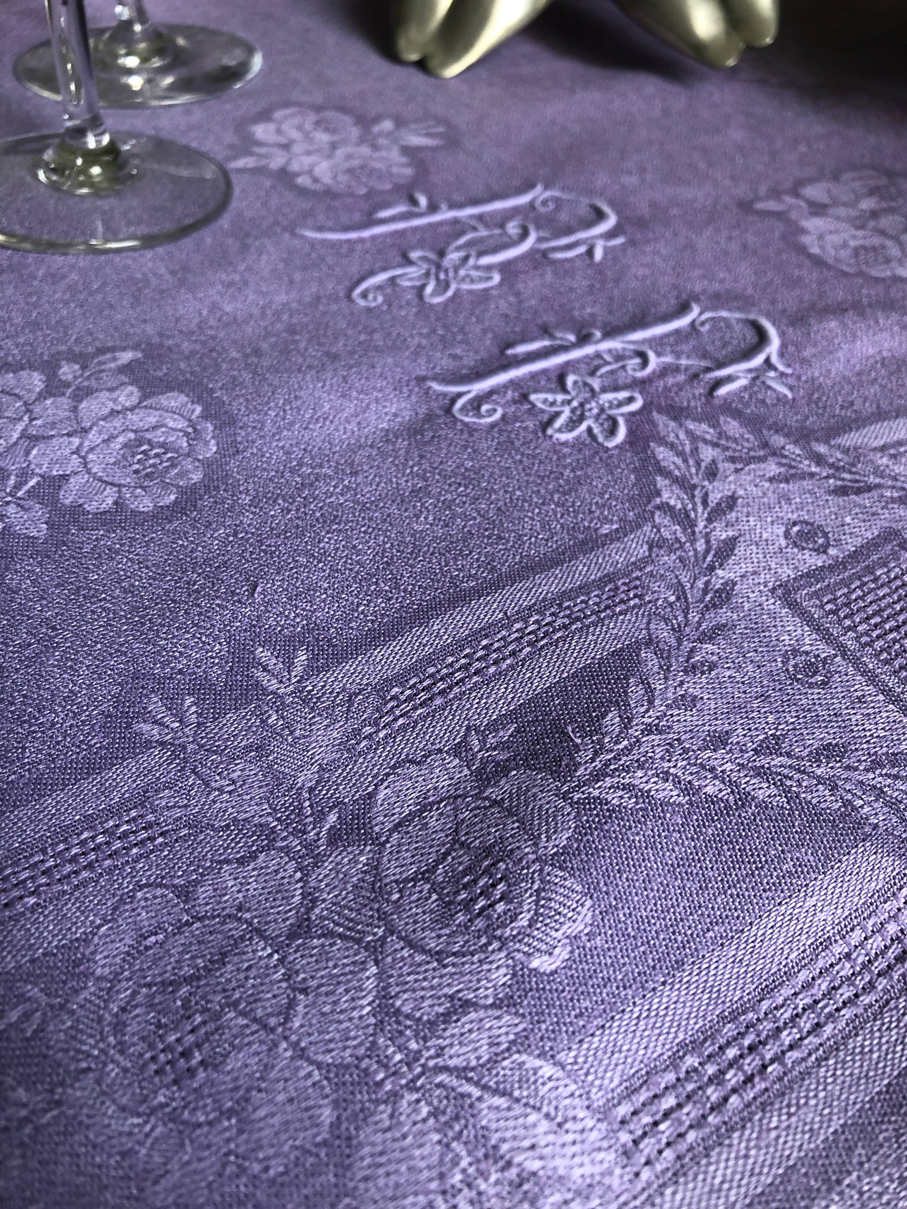 Old damask tablecloth in linen and purple silk