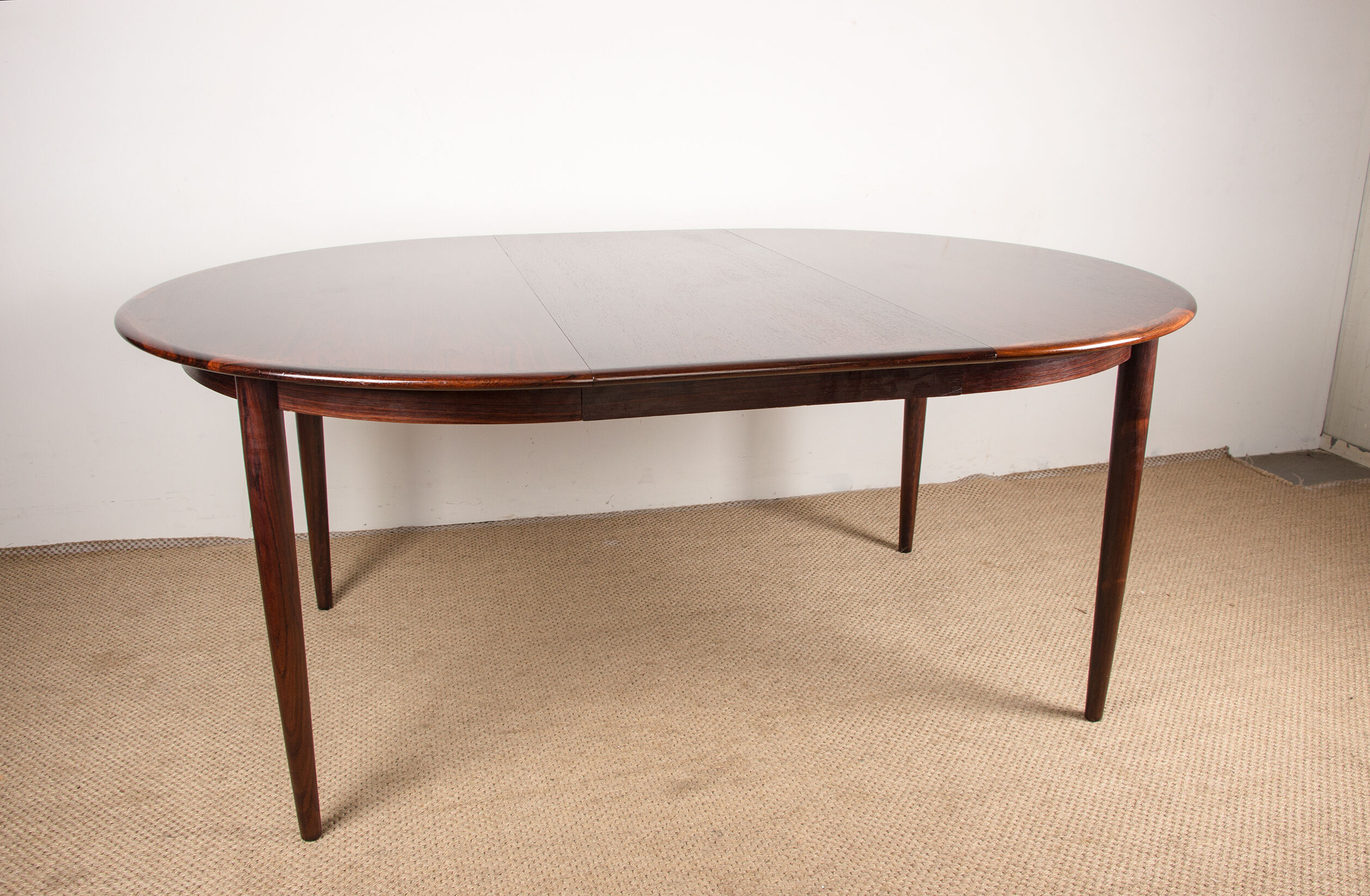 Danish extendable dining table in Rio Rosewood model 55 by Arne Vodder for Sibast 1958.