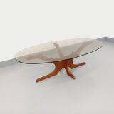 Vintage Hugues Poignant oval coffee table in teak and smoked glass from the 1970s