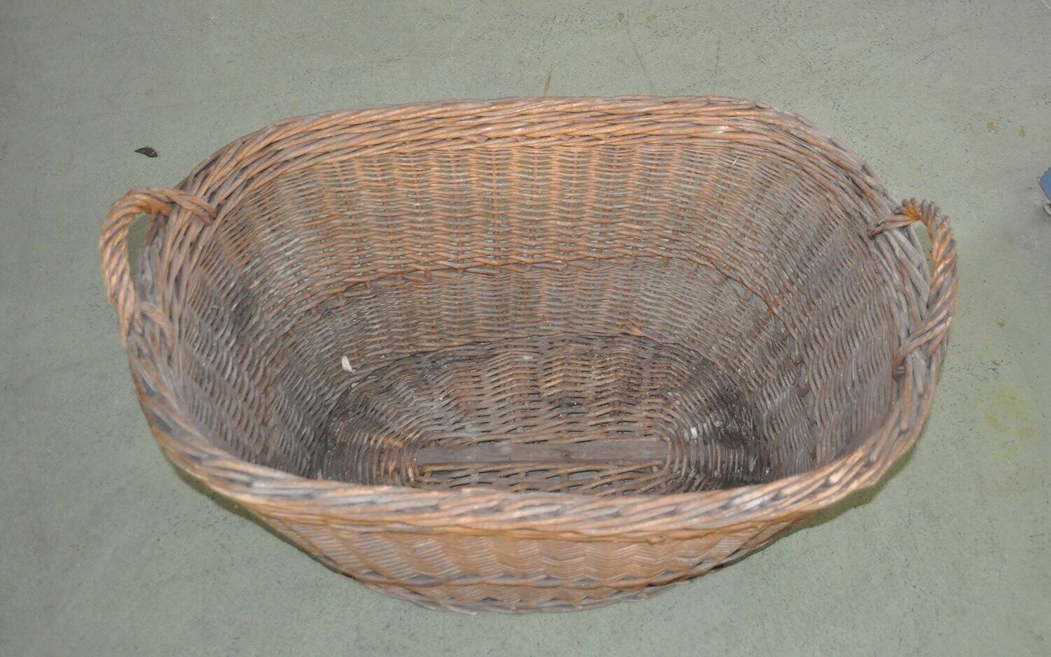 Rustic brown wicker basket from the 1940s — large oval laundry basket