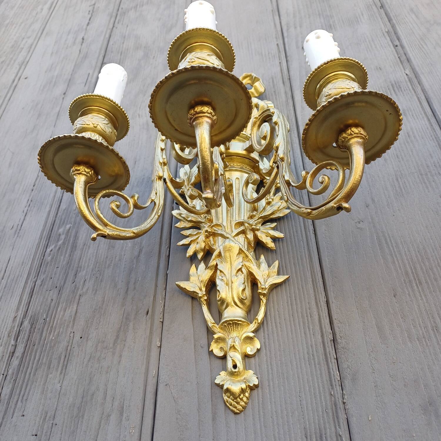 Pair of antique bronze wall sconces from the Napoleonic III era in the Louis XVI style.