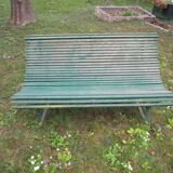 Old metal garden bench with wooden slats