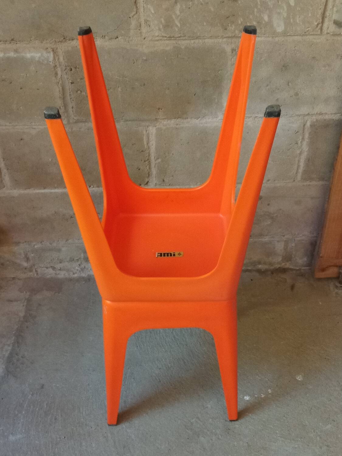 Pair of AMI stools in orange plastic