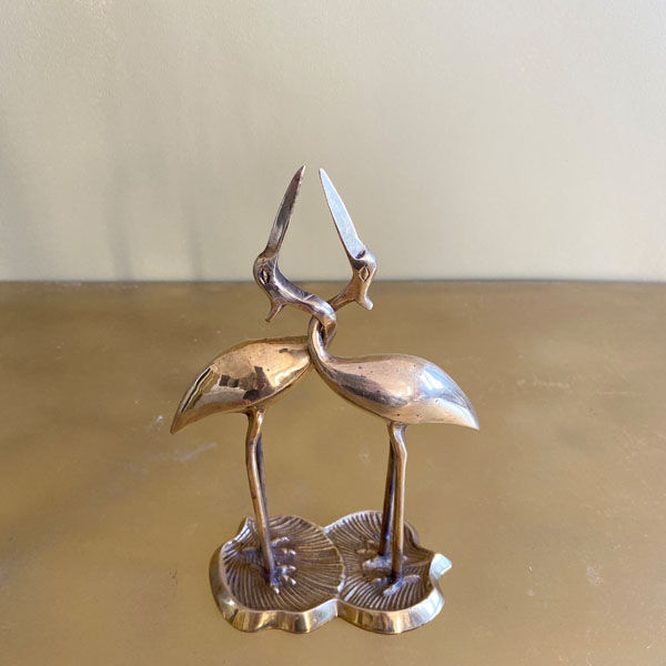 Couple of brass intertwined herons