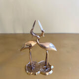 Couple of brass intertwined herons