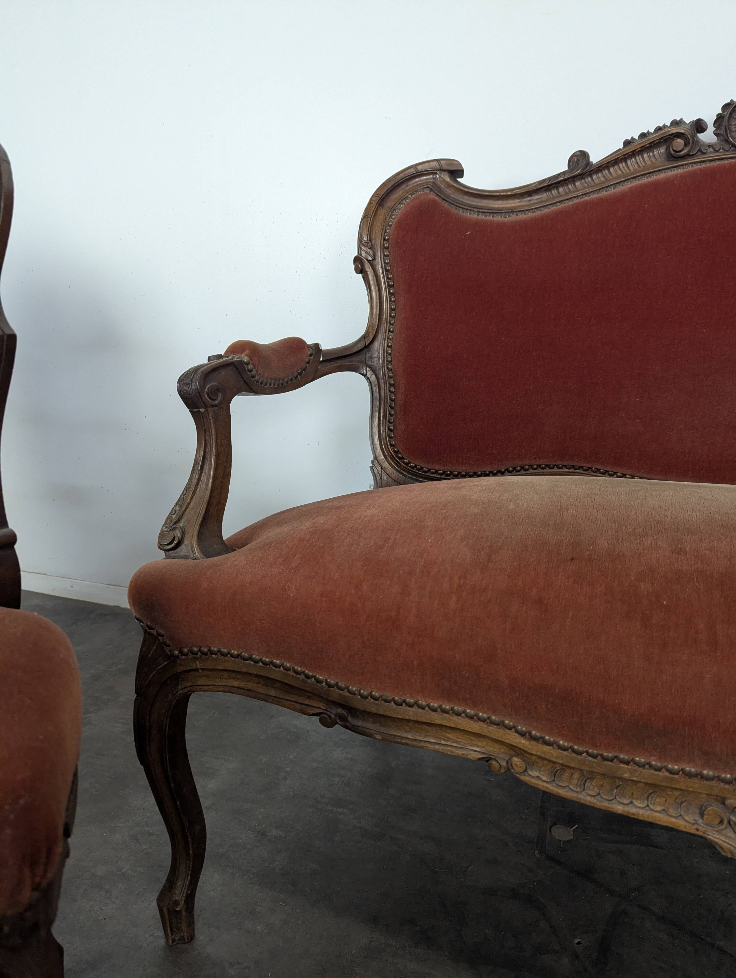 Louis XV style salon in carved walnut with orange velvet, seven pieces.