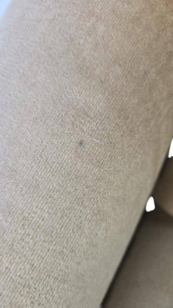 Vintage beige two-seater canapé with fringes.