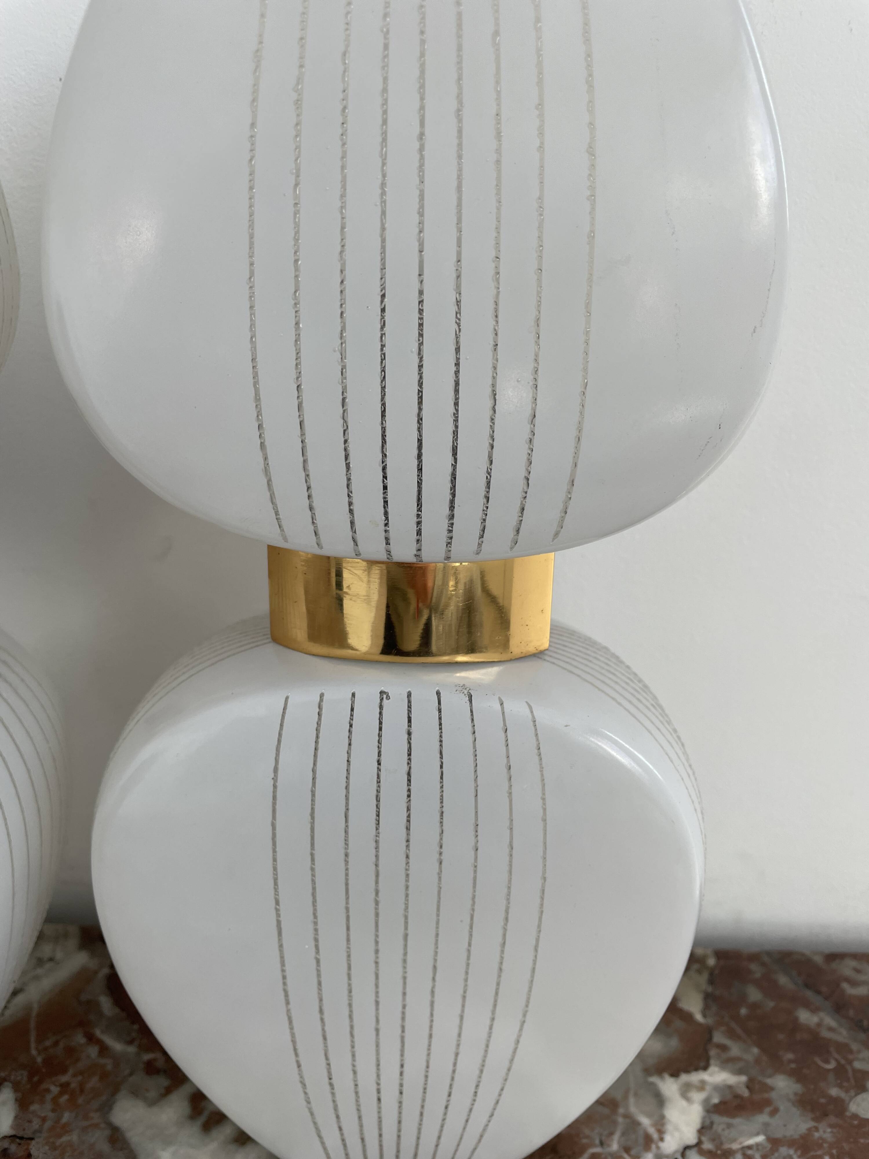 Pair of vintage wall lights from the 60s-70s in striped opaline glass and gilded brass.