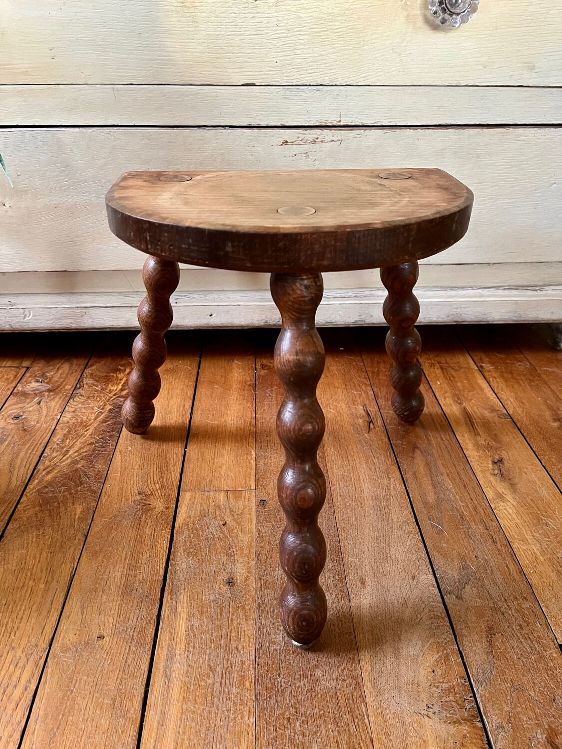 Low vintage wooden tripod stool