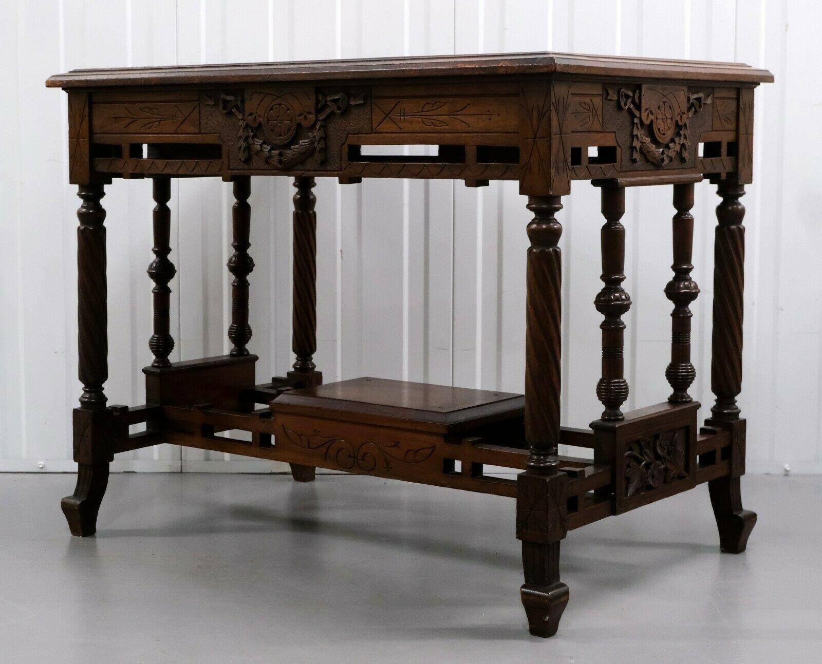 19th-century carved walnut desk with a leather top.