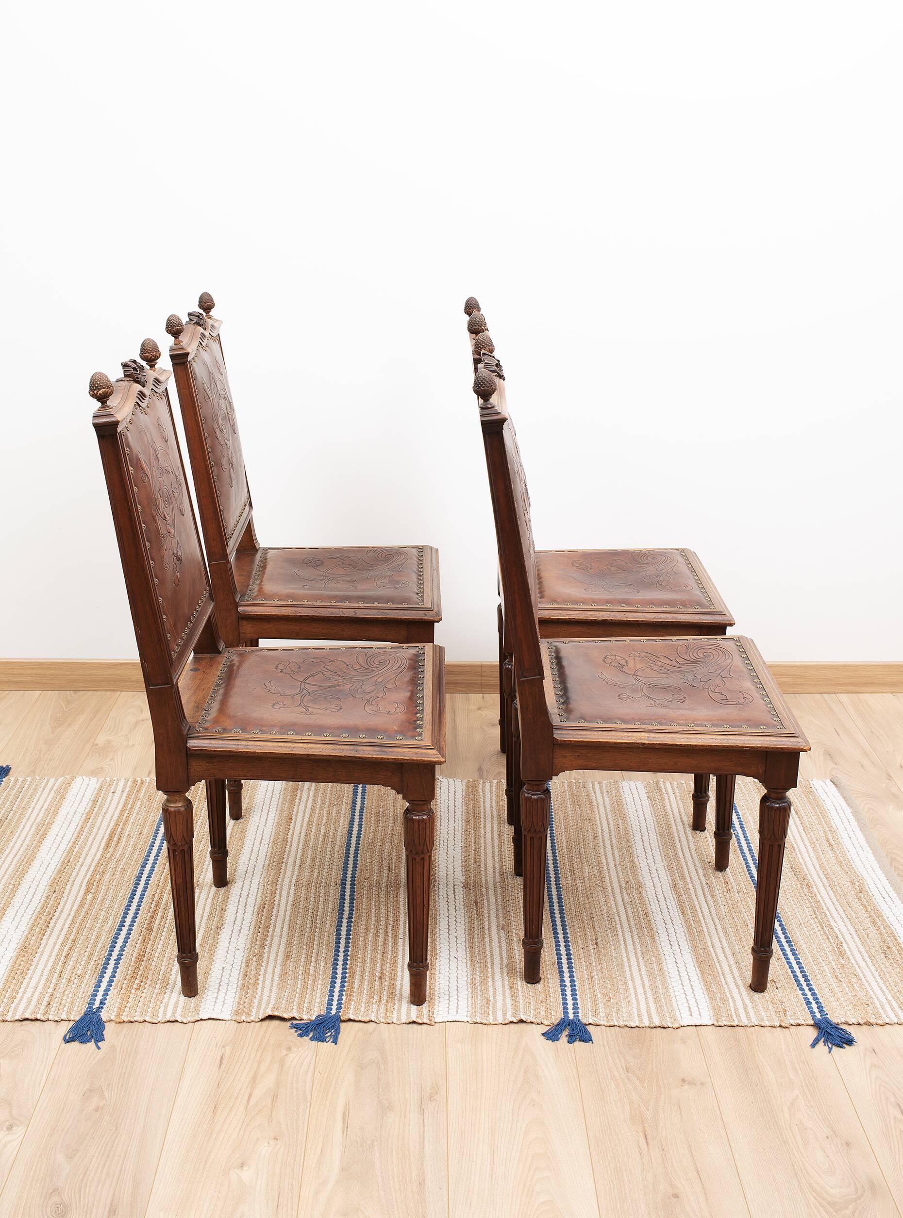 Set of 4 Louis XVI style chairs in carved wood and embossed leather.